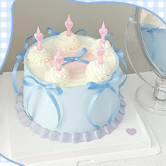 NatNarr bow cake toppers placed on a cake for a Coquette-themed display