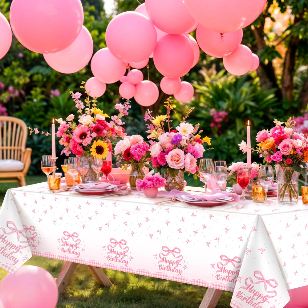 NatNarr Coquette pink bow tablecloth being wiped clean with a damp cloth.