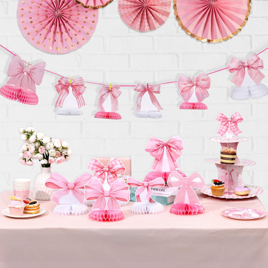 NatNarr pink bow honeycomb centerpiece creates a playful dessert table focal point.