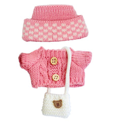 NiXiSHEEN fold-over hat detail complements the doll’s look with a refined silhouette.