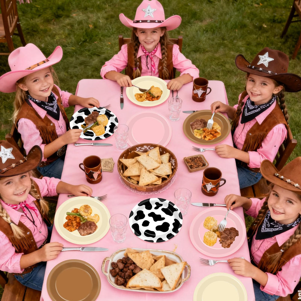 Oitnlaughter Western tableware with cow print creates cohesive rodeo themed party styling