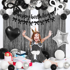 Ouddy Party black bow decorations decorate tables and walls with sleek charm.