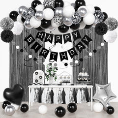 Ouddy Party black and white confetti balloons create a chic birthday focal point.