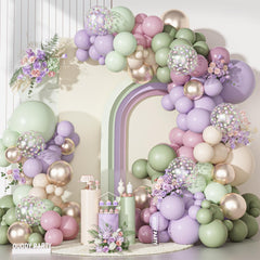 Ouddy Party 18-inch pastel balloons anchor the dusty-green arch for a striking spring focal point.