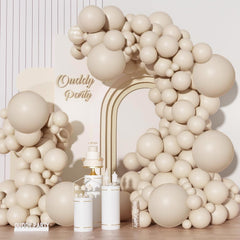 Ouddy Party sand-white 18in balloons creating a dramatic arch backdrop for photos