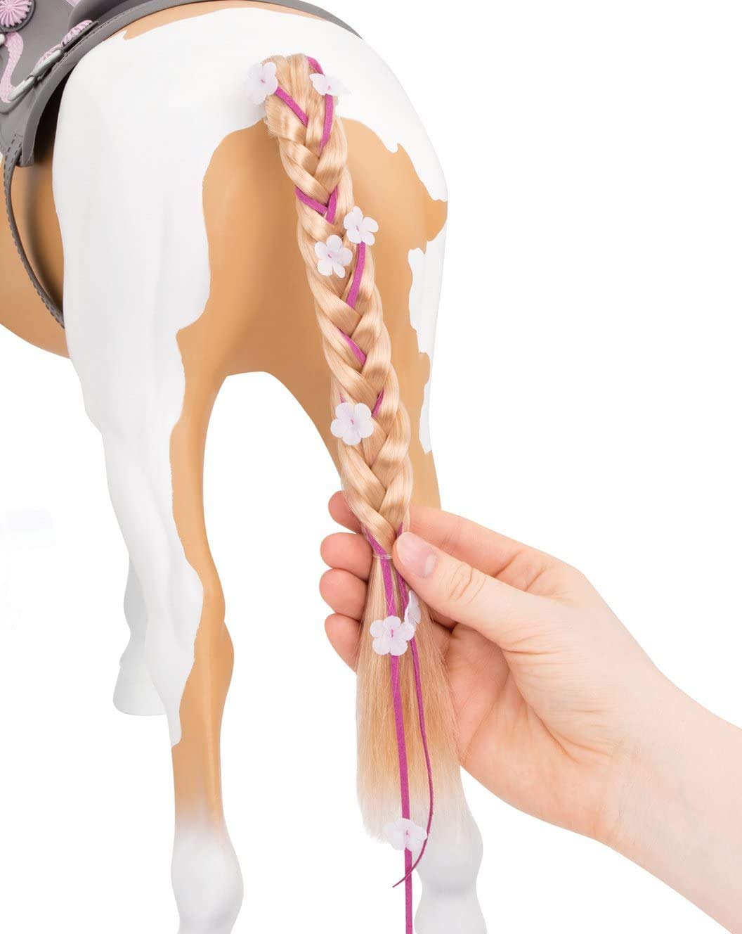 Our Generation Palomino paint horse flower ribbon adds colorful accents.