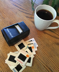 Pana-Vue 2 illuminated slide viewer in tabletop setup showing compact, portable slide viewing