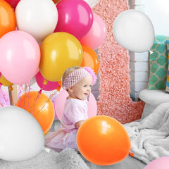 Paready birthday party decor ideas using pink and orange tones.