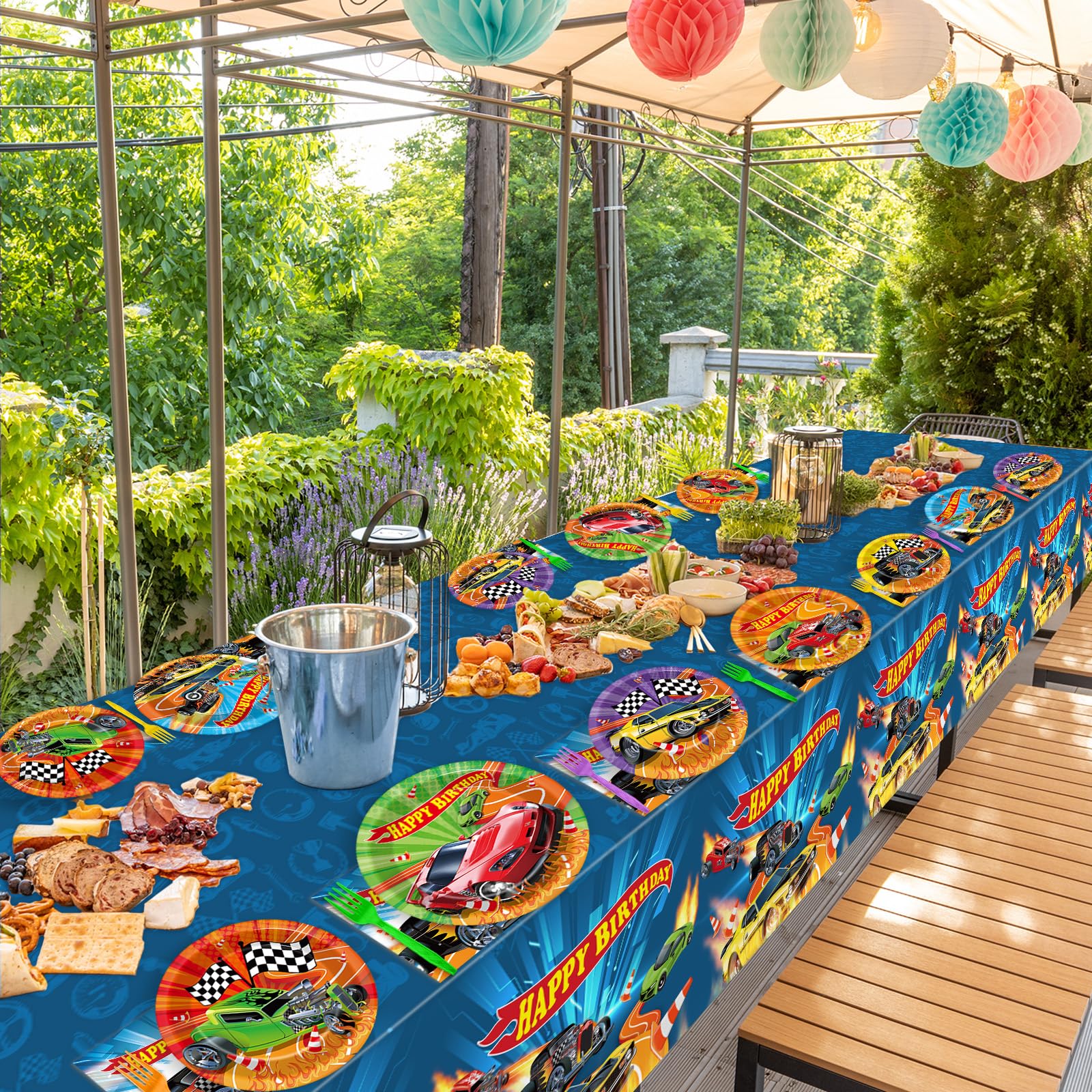 Party Greeting racing tablecloths with a central racetrack enhance the theme.