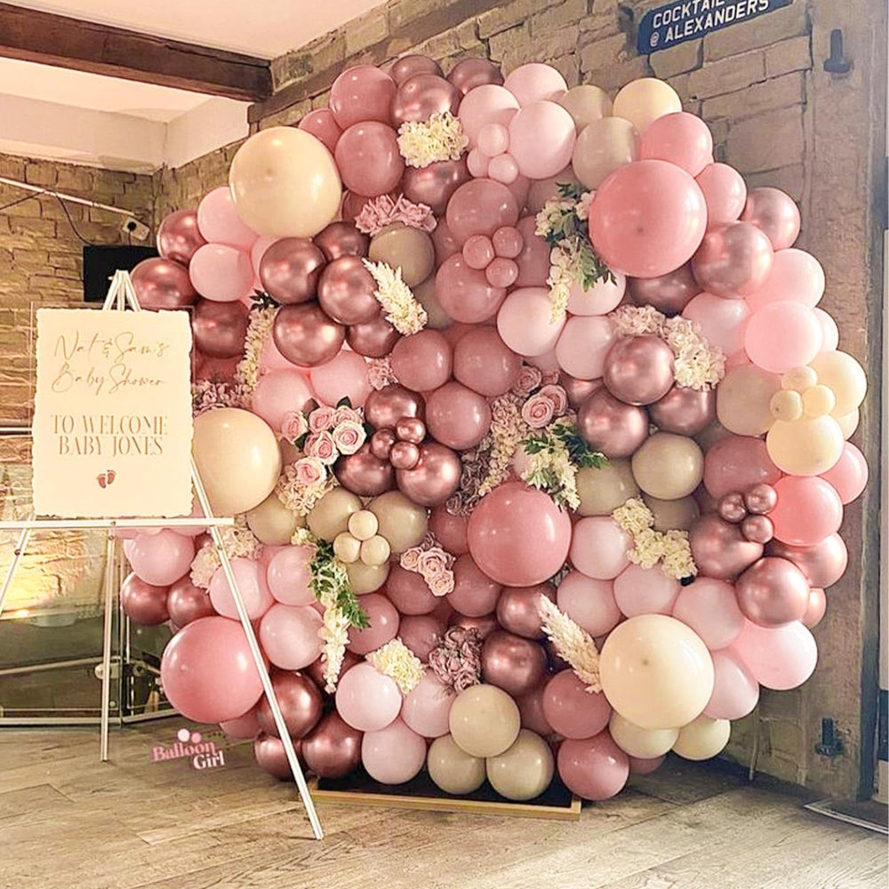 PartyWoo baby shower decor with dusty pink balloons and accents.
