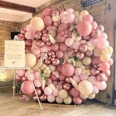 PartyWoo baby shower decor with dusty pink balloons and accents.