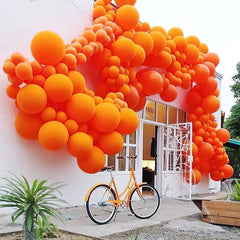 PartyWoo orange balloons graduation party accents brighten photo moments.