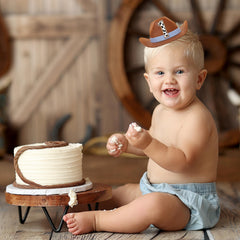 PATRDIO Cowboy 1st Birthday Hat blue worn by baby, elastic band keeps it comfy.
