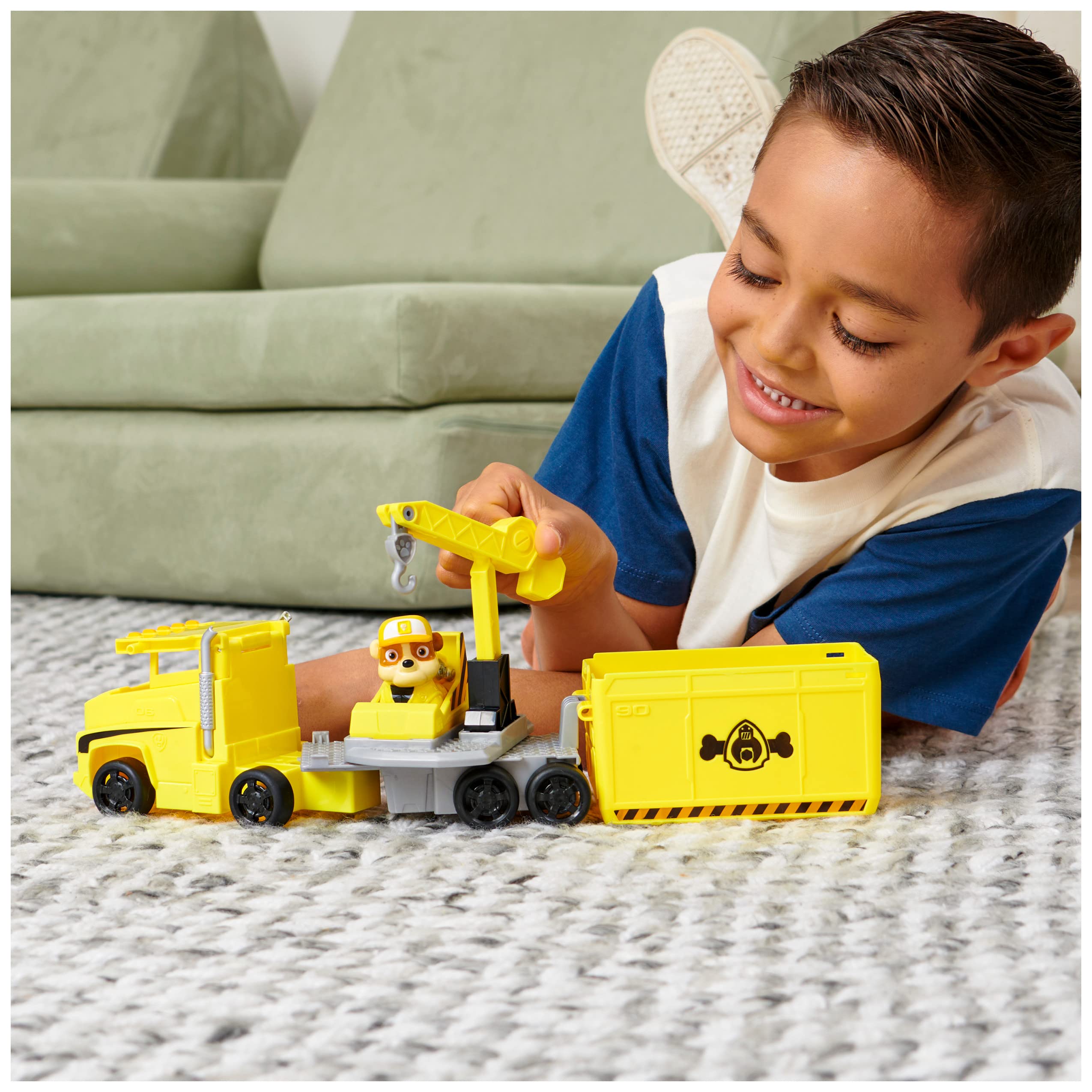 Paw Patrol Rubble figure beside the transforming truck for role-play adventures.
