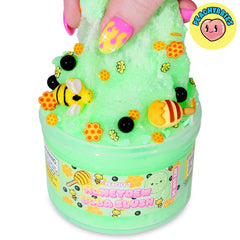 Honeydew melon chunk and bee charm in Peachybbies slime for tactile fun