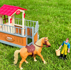 Peagprav horse-stable-playset fence defines play zones.