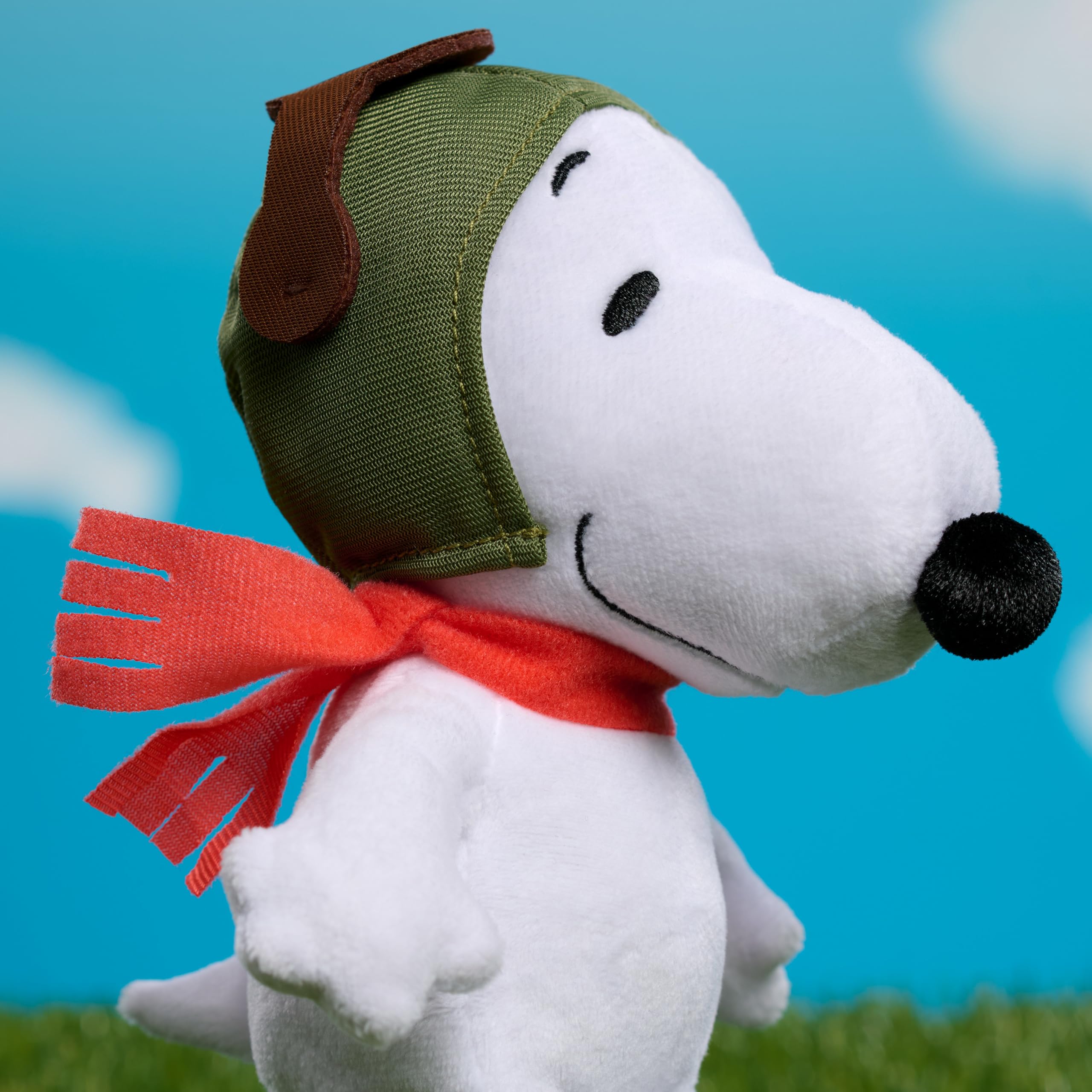 Peanuts Snoopy with red scarf and embroidery, collectible detail.