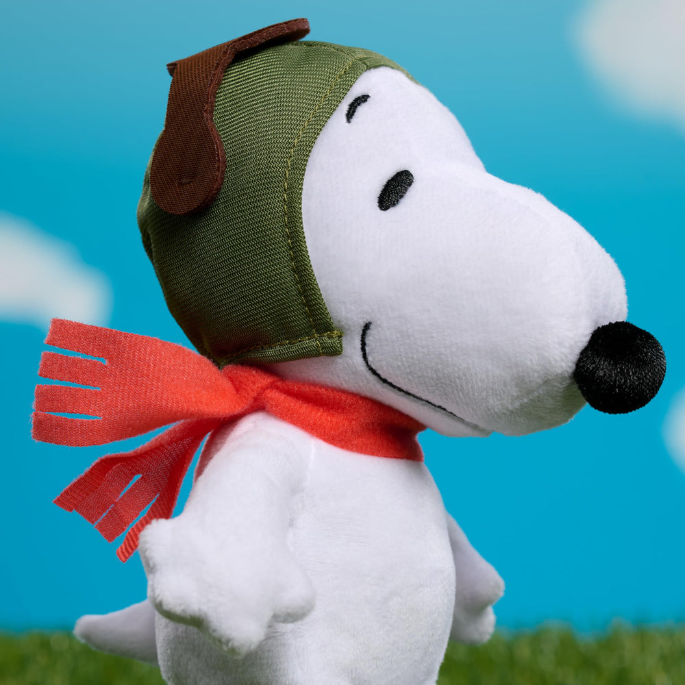 Peanuts Snoopy with red scarf and embroidery, collectible detail.