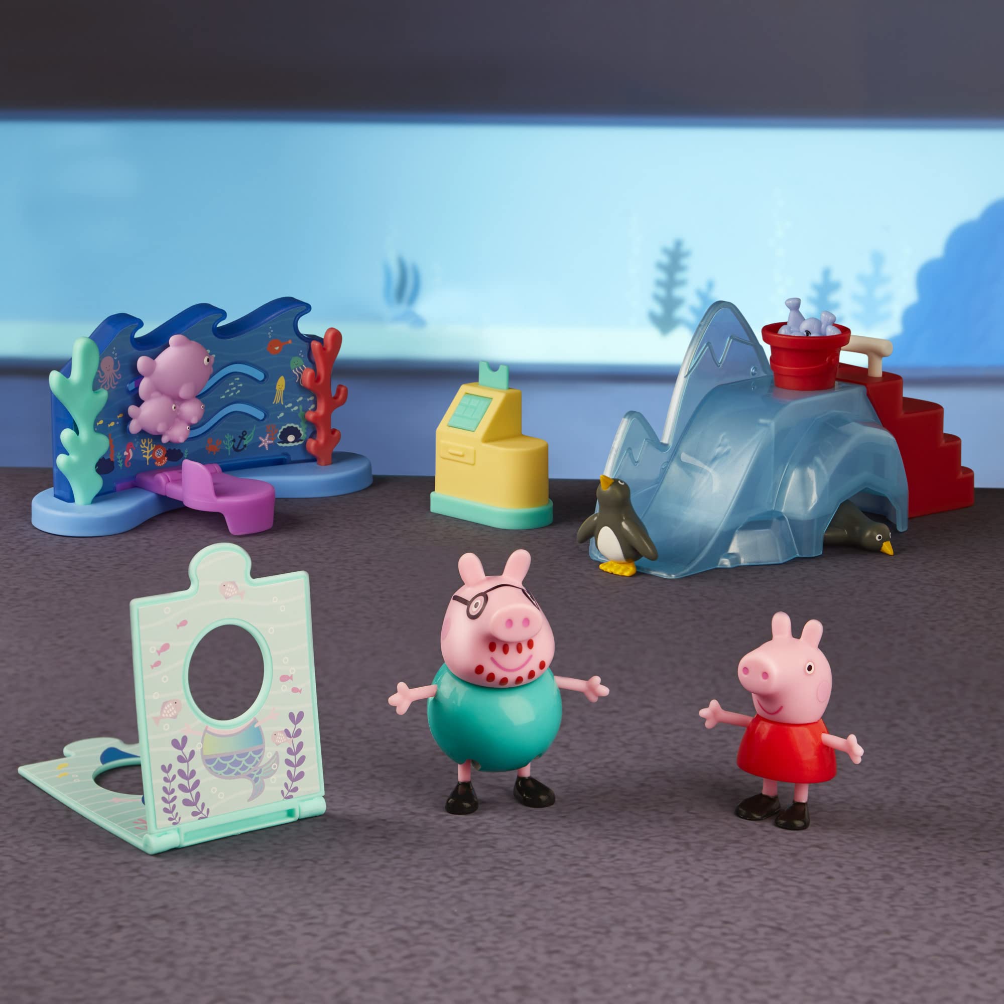 Peppa Pig Daddy Pig figure beside penguins on the ocean backdrop for imagination.
