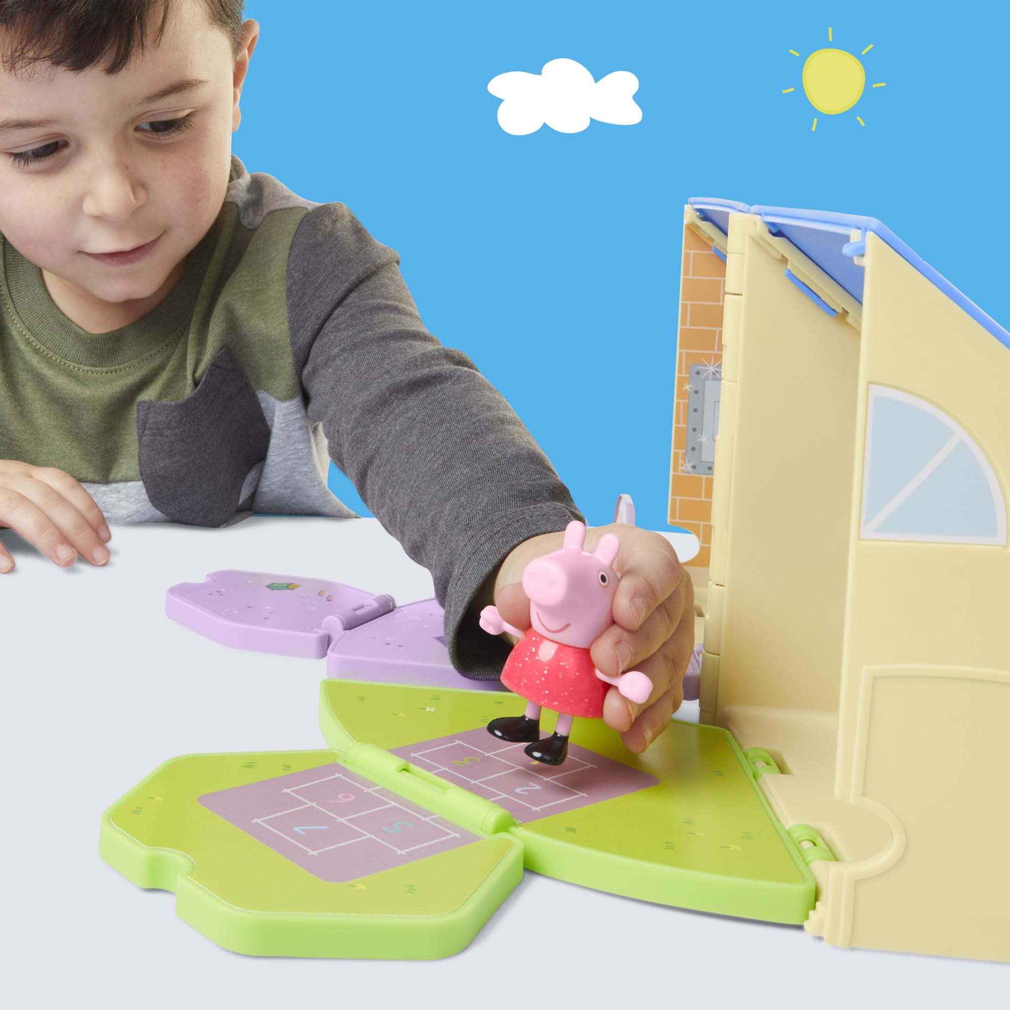 3-inch Peppa Pig figure wearing a red dress sits at playset furniture.