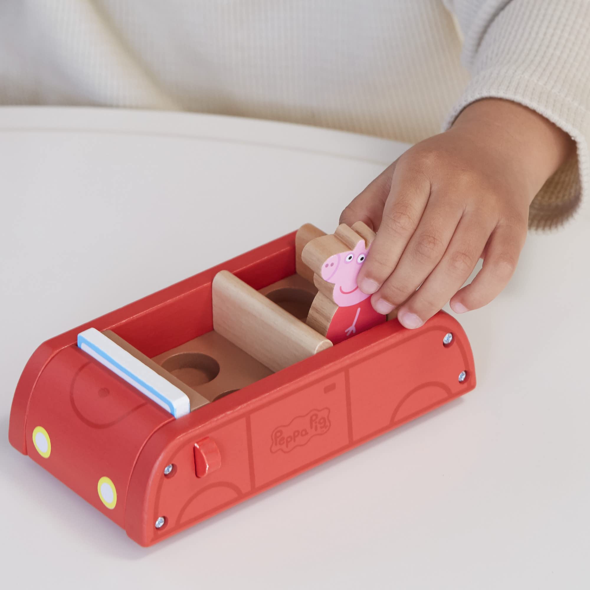 Peppa Pig figures George and Peppa sit inside the car