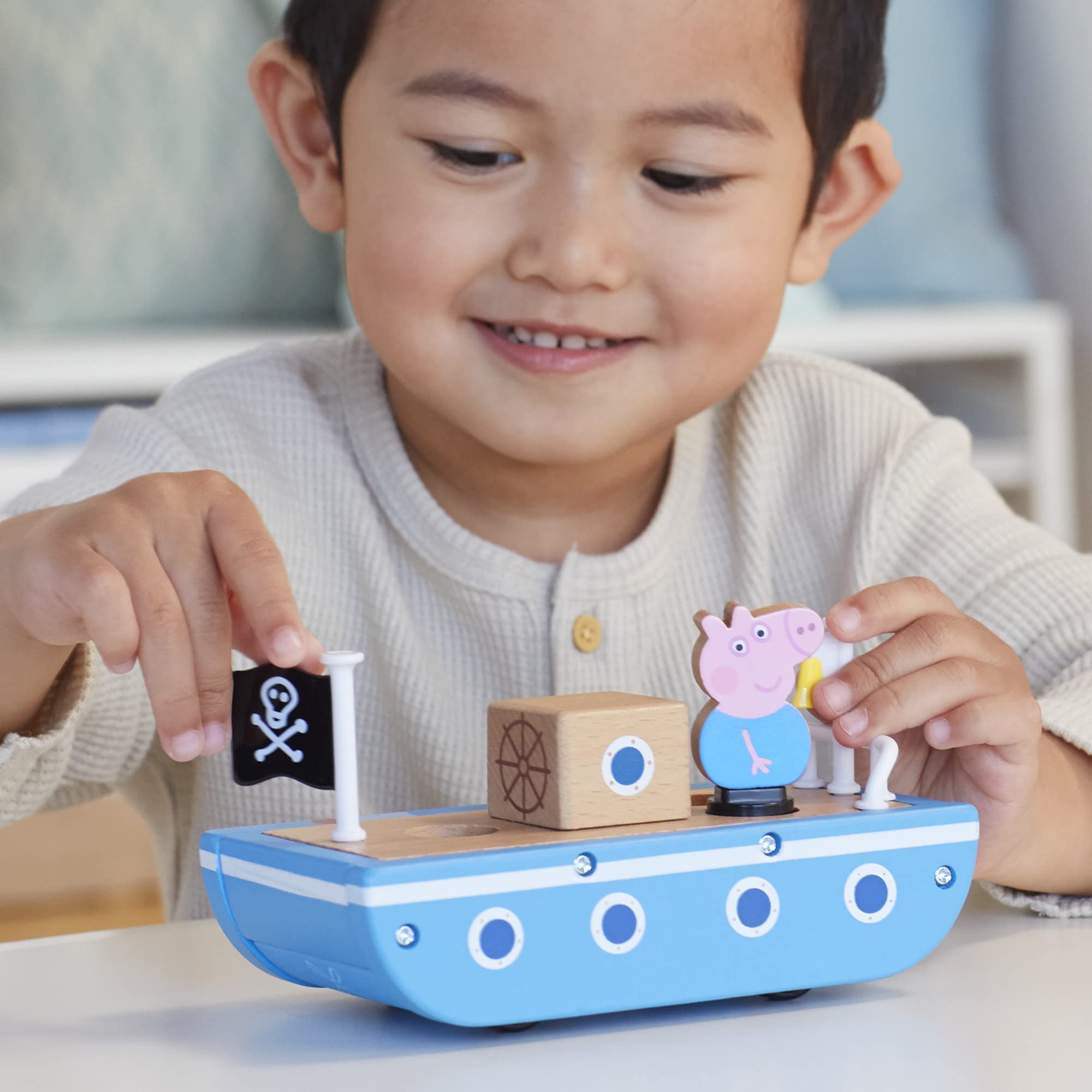 Peppa Pig figures seated in the wooden boat for playtime voyages
