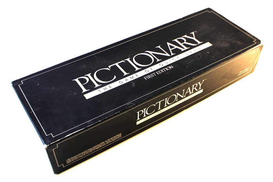 Pictionary First Edition game board with papers and timer; perfect for quick, social family game nights.