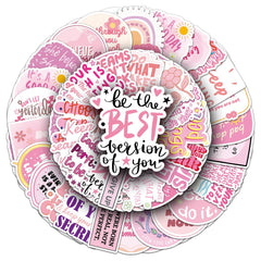 Pink motivational stickers on a laptop with positive quotes