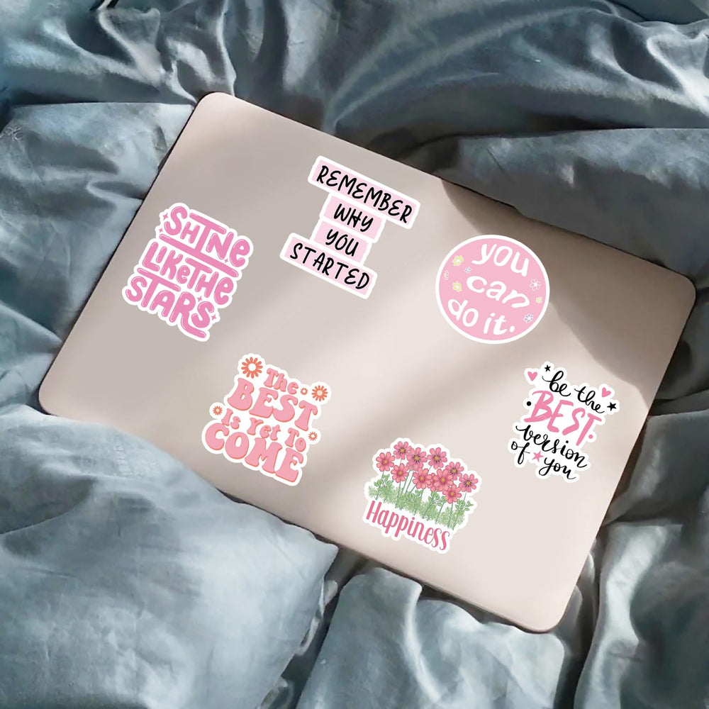 Pink motivational stickers on a notebook for personal motivation