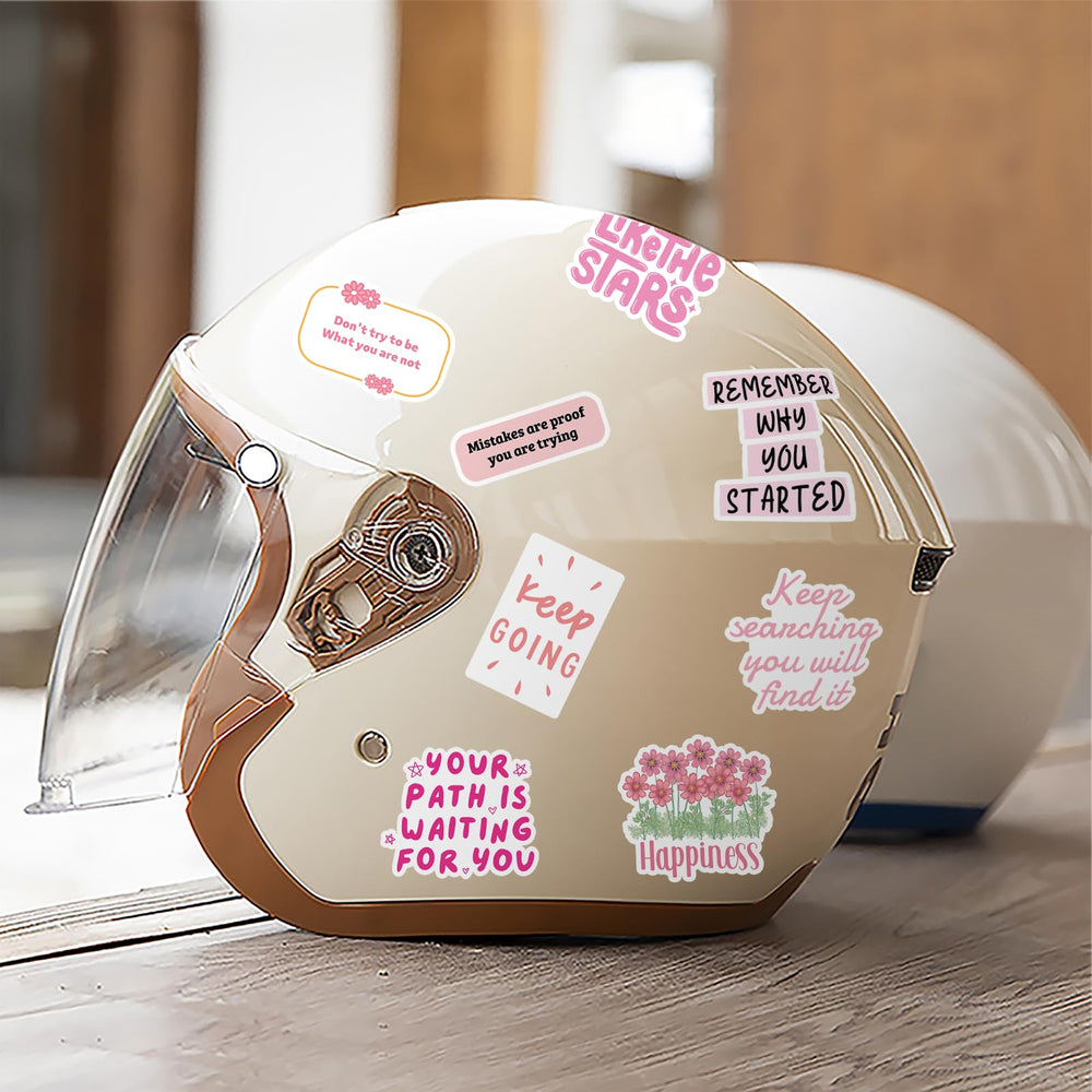 Pink motivational stickers on a travel case for adventure