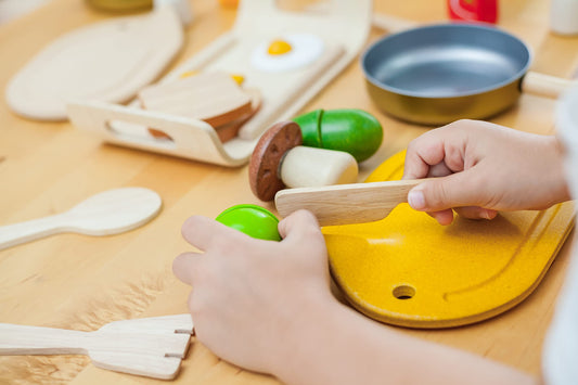 PlanToys five vegetable pieces cut and rejoined for fine motor play.