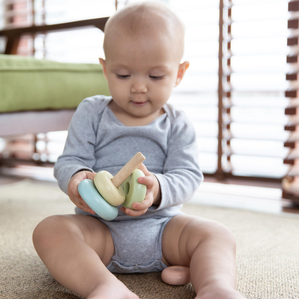 PlanToys First Stacking Ring in nursery settings, promoting color sorting and basic sequencing.