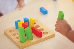 PlanToys Geometric Peg Board pegs aid precise finger control during shape matching
