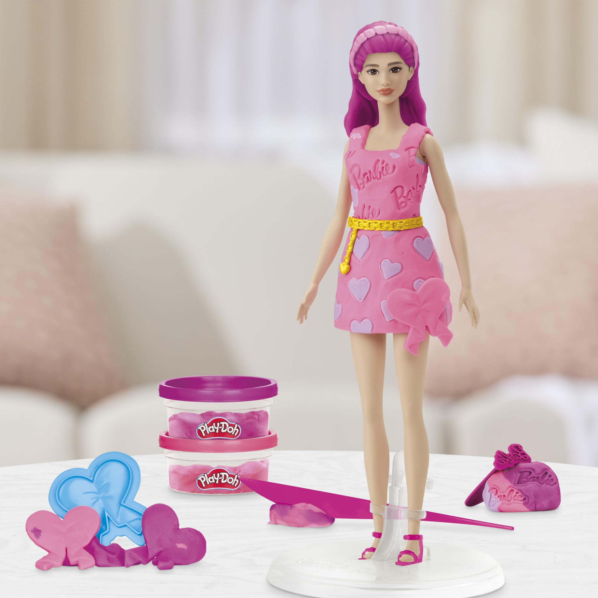 Two-ounce pink and purple Play-Doh cans expand color options for outfits.