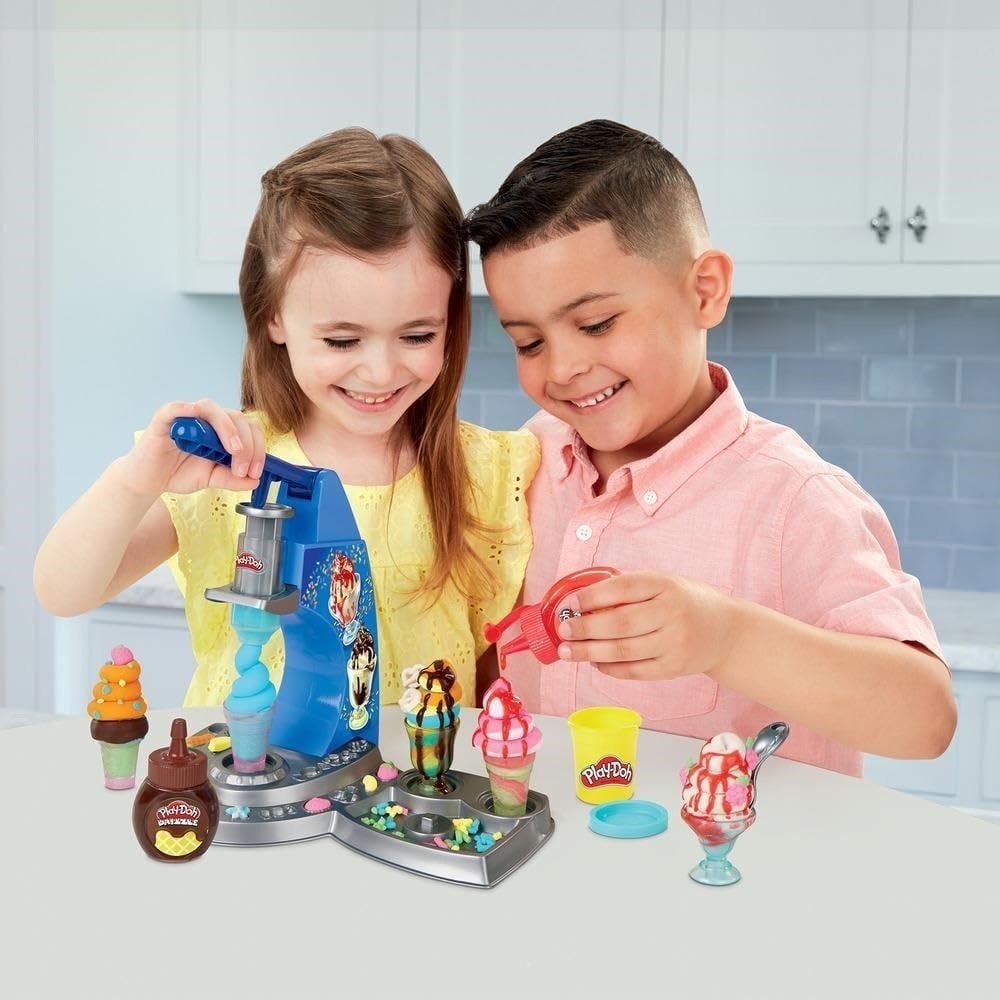 Play-Doh drizzle bottles enable pretend candy coating for creative decorating.
