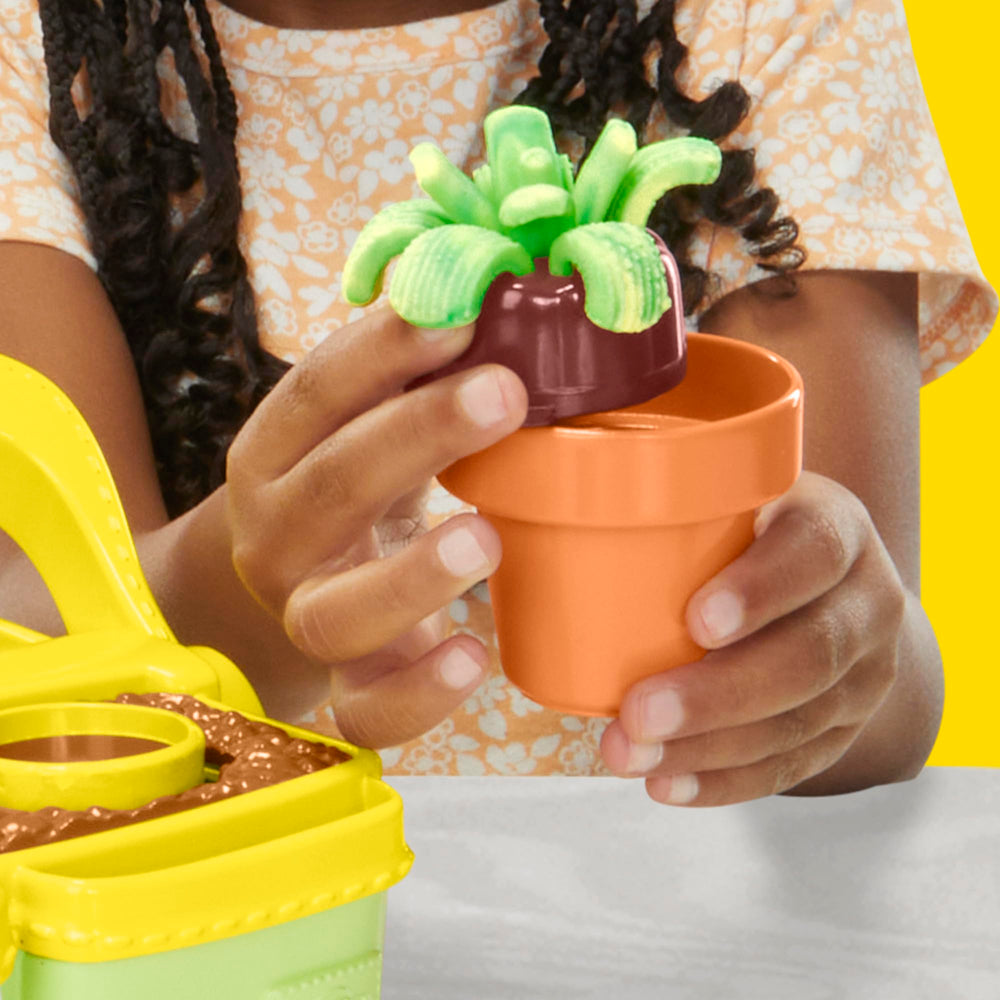 Play-Doh Blooming Flowers pucks and book-mold create varied blossoms.