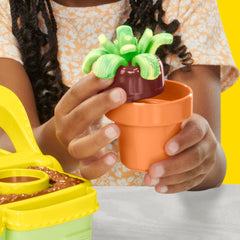 Play-Doh Blooming Flowers pucks and book-mold create varied blossoms.