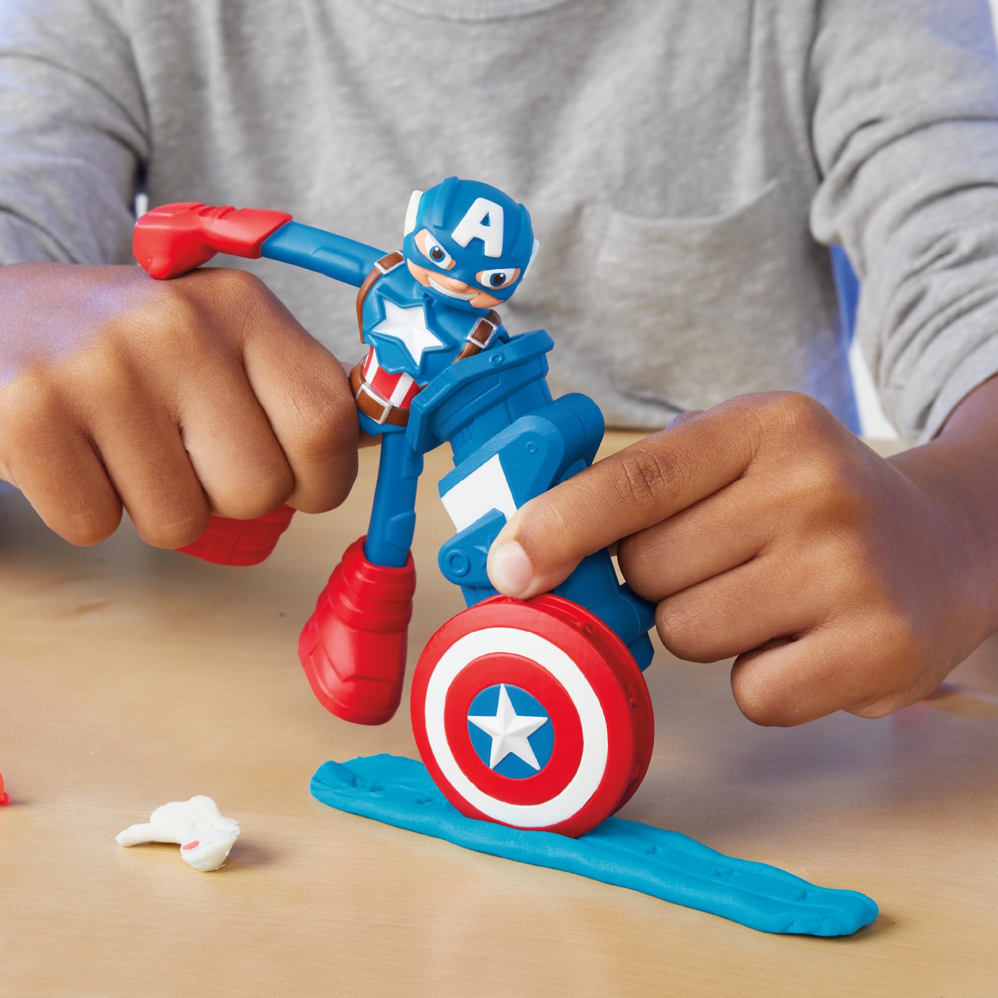Play-Doh shield stamper accessory creates star prints on clay for unique textures