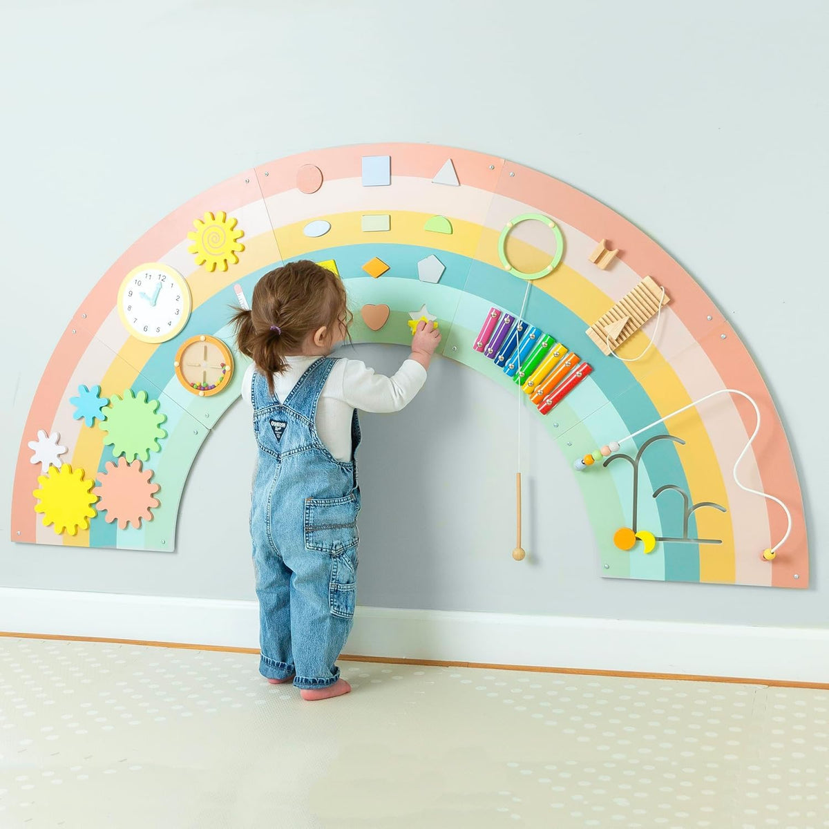Play Platoon sensory wall panel in rainbow design ready for toddler exploration.