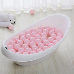 PlayMaty ball pit setup with pink balls in a home play area.