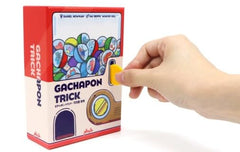 Playte Gachapon Trick money tokens underscore economic tension during play.