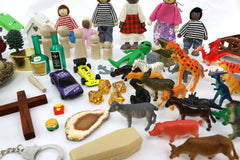 Two families and houses in PlayTherapySupply Sandtray Starter Kit support relational narratives.