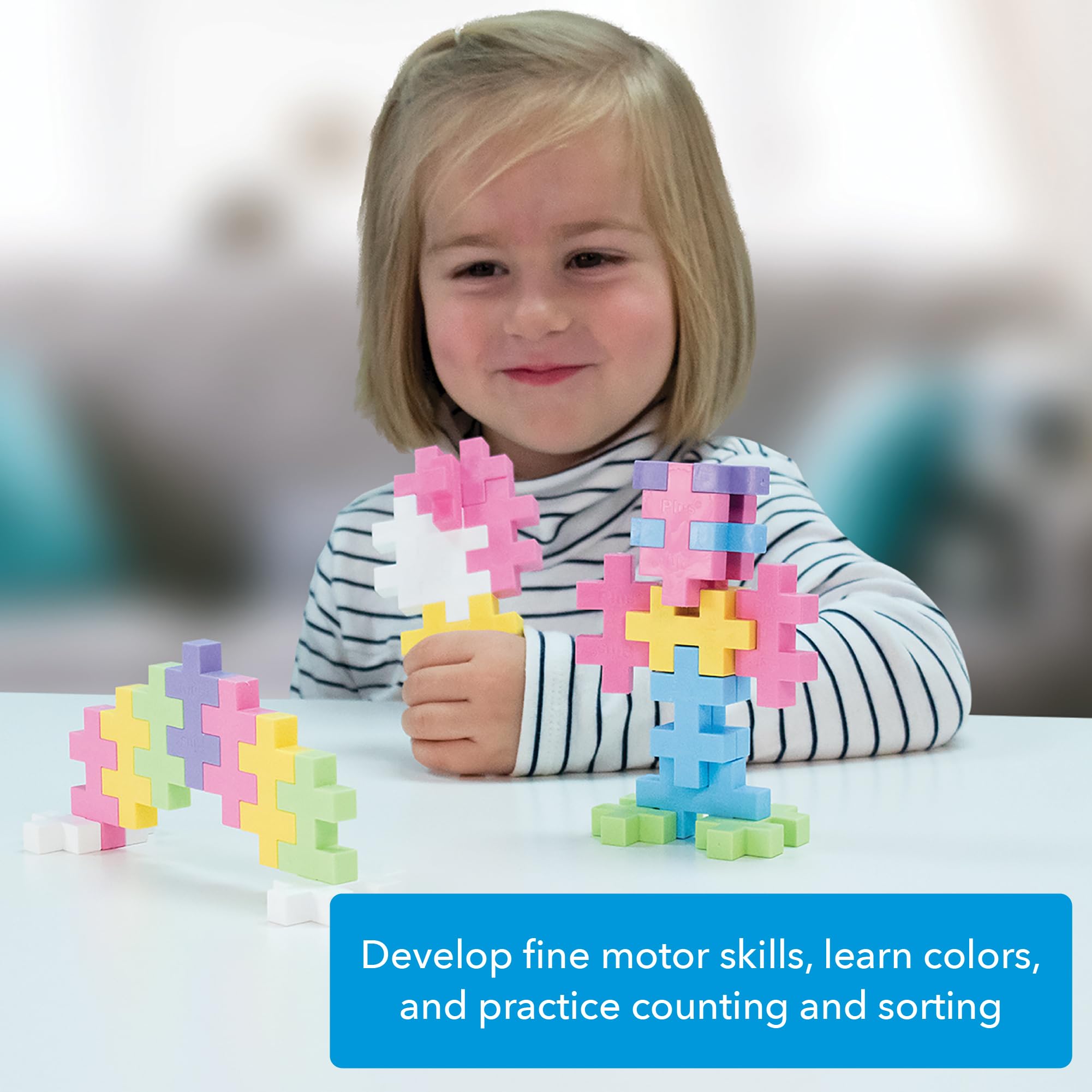 PLUS PLUS Big kid playing with pastel blocks in a cozy setting