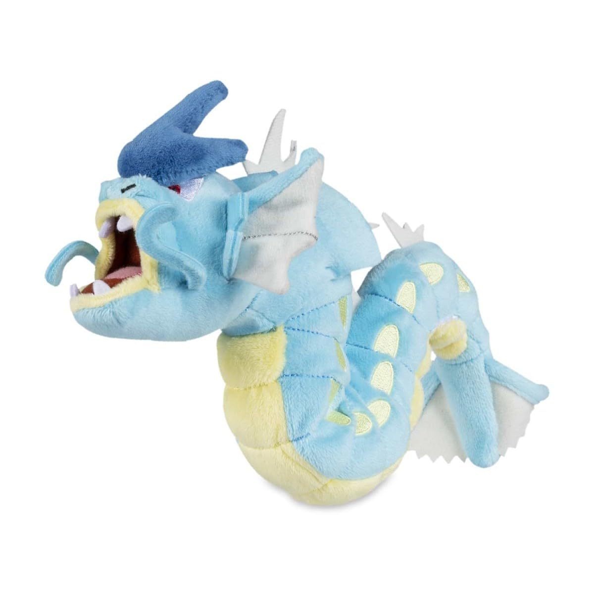 Pokémon Center Gyarados Sitting Cuties Plush upright on a desk for playful display.