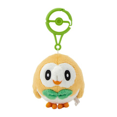 Pokemon Center Rowlet plush with carabiner clipped to a backpack for easy travel.