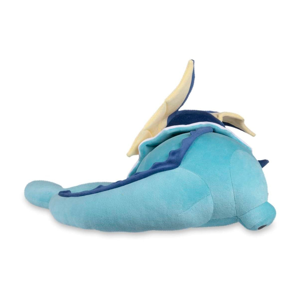 Pokémon Center Sleeping Vaporeon plush on bed, a cozy bedside companion