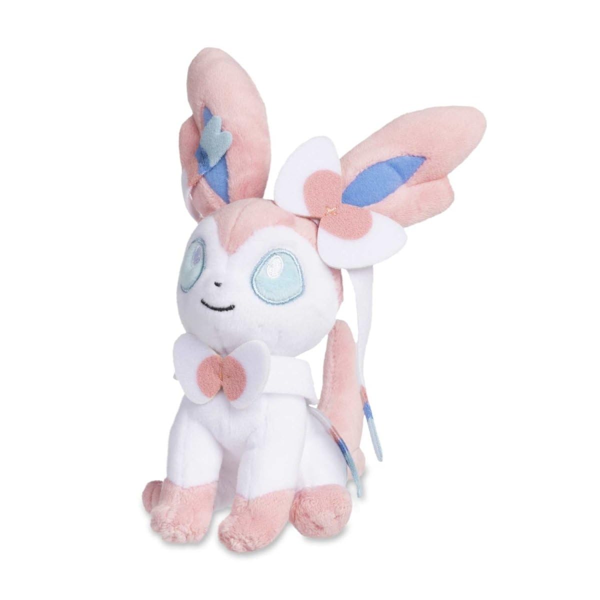 Pokemon Center Sylveon Sitting Cuties Plush sits up on a desk for cute desk decor.