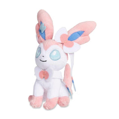 Pokemon Center Sylveon Sitting Cuties Plush sits up on a desk for cute desk decor.