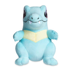 Pokemon Center Totodile plush side view highlighting embroidered features for durable cuddling.