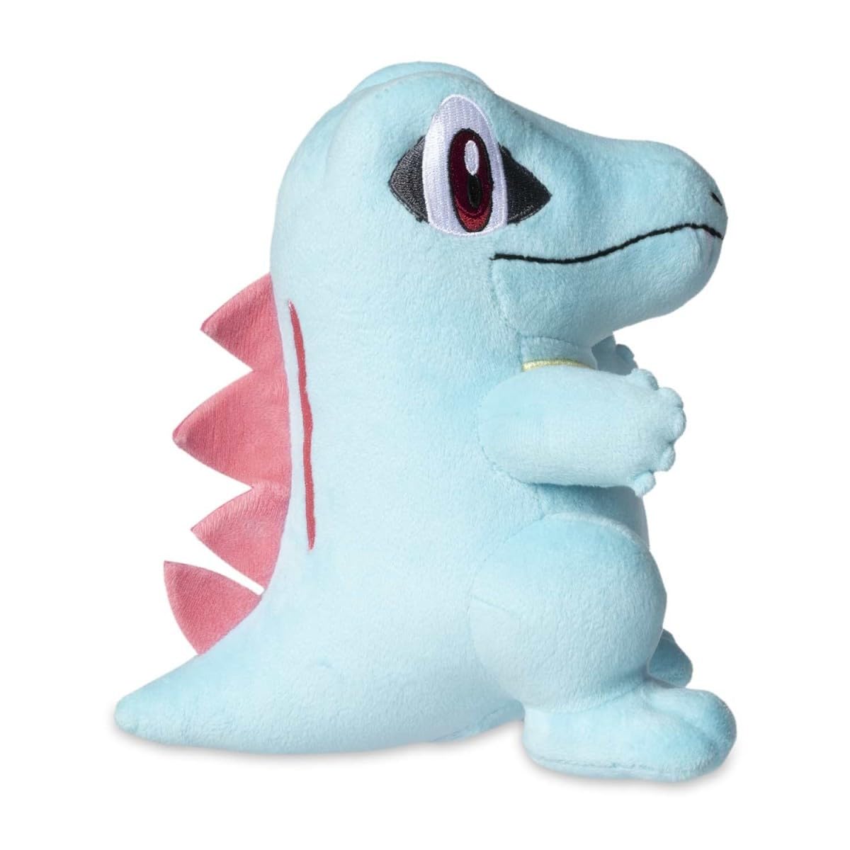 Pokemon Center Totodile plush texture close-up shows zigzag back spikes and felt teeth.